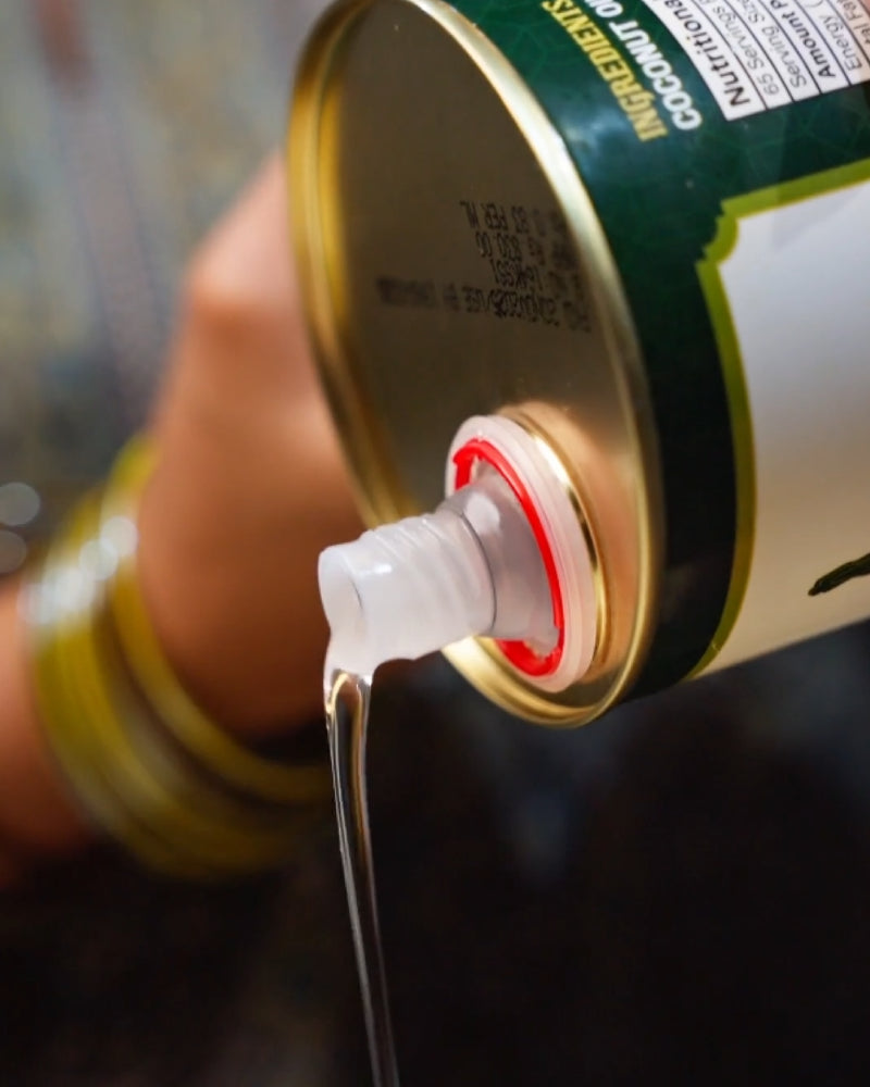 Hand pouring Coconut oil from a Tin, blurred background